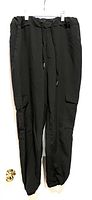Full view photo of black lightweight joggers showing front, elastic waistband, drawstring, and cargo pockets on sides.