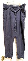 Front view of blue linen pants showing elastic waistband and braided drawstring