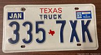 Front of Texas Truck license plate with number 335 7XK, dated January 1993.