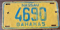 Front view of yellow and blue painted metal license plate from Nassau, Bahamas with number 4690.