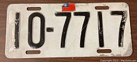 Front side of the license plate showing raised black numbers (10-7717) and Taiwan flag emblem