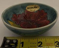 Measurement tape alongside the bowl showing approximately 2.5 inches diameter.