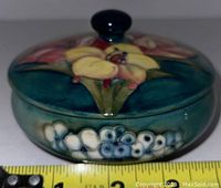 Front angle showing floral motif, lid, and box