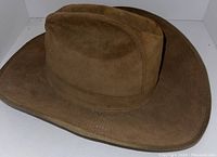 Main view of the brown suede wide-brim hat showing overall design and condition.