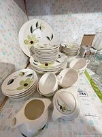 Full view of stacked Blue Ridge floral dinnerware including plates, bowls, cups, creamer, sugar bowl