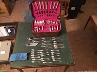 Top wide angle view showing full collection of cutlery and the wooden storage box.