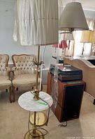 Full view of the floor lamp showing the stone table, metal base, and lampshade.