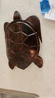 Top view of the carved wooden sea turtle showing detailed carved shell pattern and smooth polished finish.