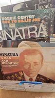 Photo showing several Frank Sinatra albums, Bobbie Gentry album, and Tribute to Durante album in a box.