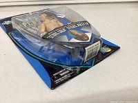 Side view of the unopened 1997 WWF Stone Cold Steve Austin action figure in blister packaging showing figure and card back.