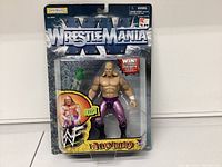 Front view of unopened 1998 WWF WrestleMania XVIII Triple H action figure in original blister pack with figure and accessories clearly visible.