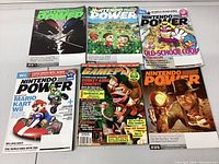 Photo showing six magazine covers including multiple Nintendo Power issues and one GamePro issue