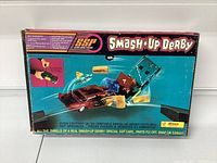 Front view of original box featuring promotional graphics of smashing cars and item details