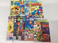All comics laid out face up showing covers including Slimer, Flintstones, and others.