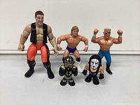 Front view showing all five wrestling figures with details of clothes, paint, and pose
