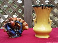 Front view of colorful ceramic dolphin figurine and yellow McCoy pottery vase