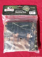 Photo of the Mossy Oak inflatable hunting seat in its original sealed packaging with label visible.
