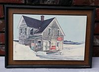 Full front view of framed vintage lithograph showing old abandoned grocery store with Coca-Cola signs in a snowy landscape.