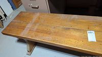 Top view of wooden bench showing worn surface and scratches