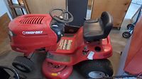 Side view showing red hood, Troy-Bilt branding and front wheels