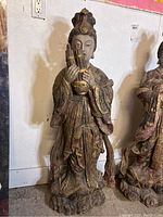Full front view of the statue showing entire figure and base
