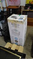 Boxed Graco Pack 'N Play featuring reversible napper and changer with packaging showing product illustration and brand.