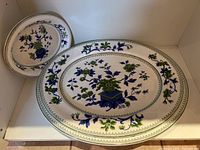 Two oval serving platters stacked showing large and medium sizes