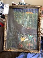 Full view of framed oil painting with dark feline figure and mystical forest scene, signed and dated.