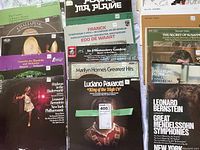 Close-up photo showing the front covers and titles of some classical vinyl LP albums stacked side by side, including Luciano Pavarotti, Leonard Bernstein, Edo de Waart, Marilyn Horne, and others.