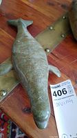 Top view of soapstone whale carving showing the dorsal side with pectoral fins and tail.