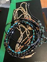 Set of color-varied beaded necklaces showing wood, stone, and magnetic beads in mixed styles.