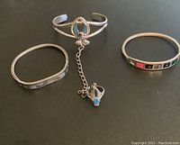 Front view of all three items showing the bracelet-ring combo with turquoise detail in the center and the two other bracelets on sides