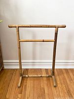 Full view of the boho bamboo towel rack showing its two-tier construction and bamboo material.