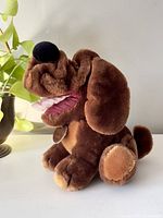 Side view of brown Wrinkles dog stuffed animal plush showing facial wrinkles, large nose, open mouth, and front paws.