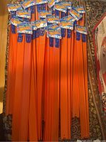 Full lot showing multiple straight track pieces stacked together with product tags visible.