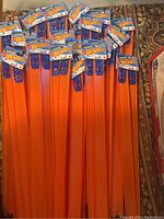 Top view of multiple brand new Hot Wheels 24-inch straight track pieces with packaging showing Mattel and Hot Wheels logos.