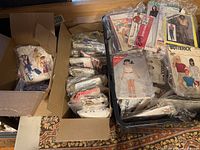 Three boxes filled with numerous vintage sewing patterns from McCall's, Simplicity, Butterick, and ESP.