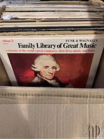 Photo showing a boxed collection of vintage vinyl records with the front record cover featuring the Funk & Wagnalls Family Library of Great Music Album 21 with a historical portrait of a composer.