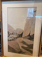 Full view of framed painting showing rock landscape scene