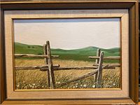 Full front view of framed painting showing landscape scene and gold-tone frame