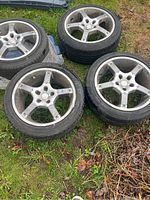 Overview of all four wheel and tire assemblies laid on grass