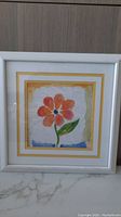 Front view of framed series print showing an orange daisy flower with double mat in white frame.