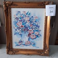 Full view of the Angie Strauss floral print displayed in an ornate gold decorative frame with intricate carved details at the corners and edges.