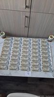 Front face side of uncut sheet showing all forty 1 CAD notes arranged in rows