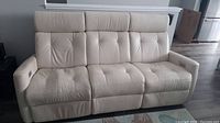 Front view of the entire sofa showing seating configuration and overall condition
