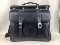 Front view of the black leather briefcase showing two buckle closures and carrying handle