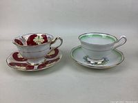 Front view of two Royal Albert fine bone china tea cup and saucer sets, highlighting coloration and form.