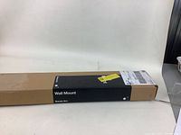 Long rectangular box showing 'Wall Mount' and 'Sonos Arc' labeling on black section of the box.