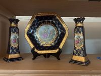Full view of the octagonal Limoges plate and two matching candleholders