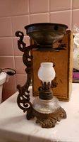 Vintage Vapo-Trane vaporizer, ornate metal with frosted glass globe, in front of original box